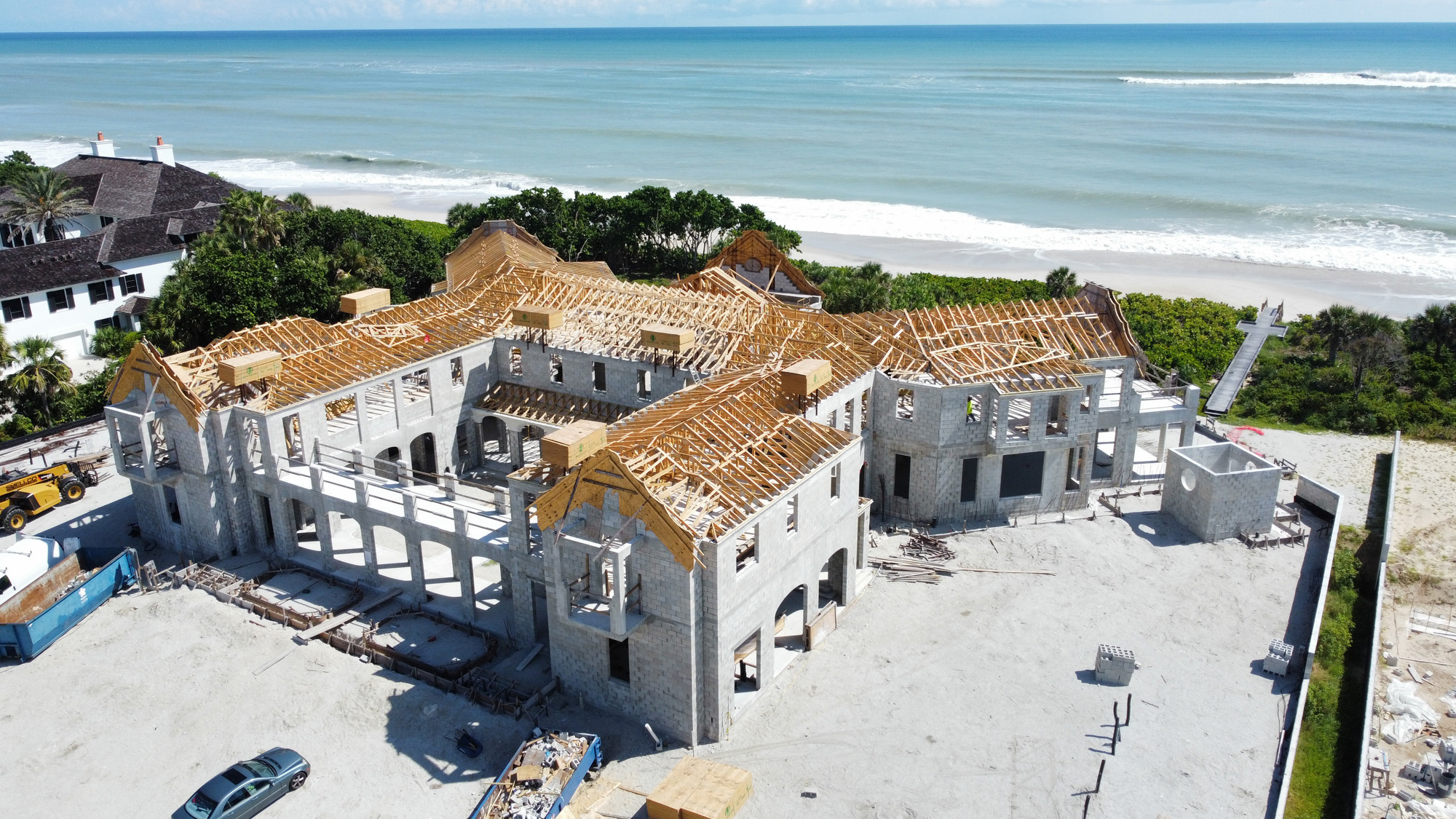 Shellco custom home under construction — roof framing and structural work